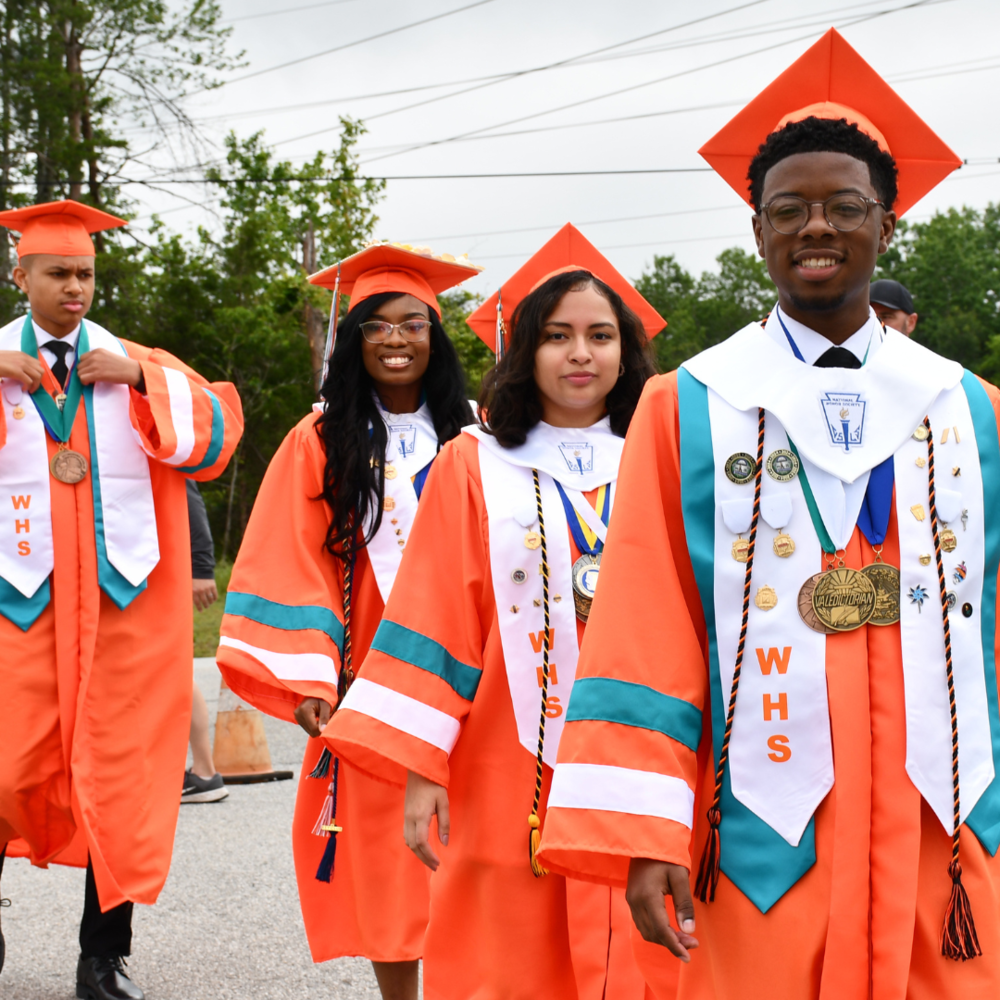 four students graduating