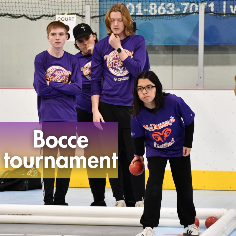 four students playing bocce