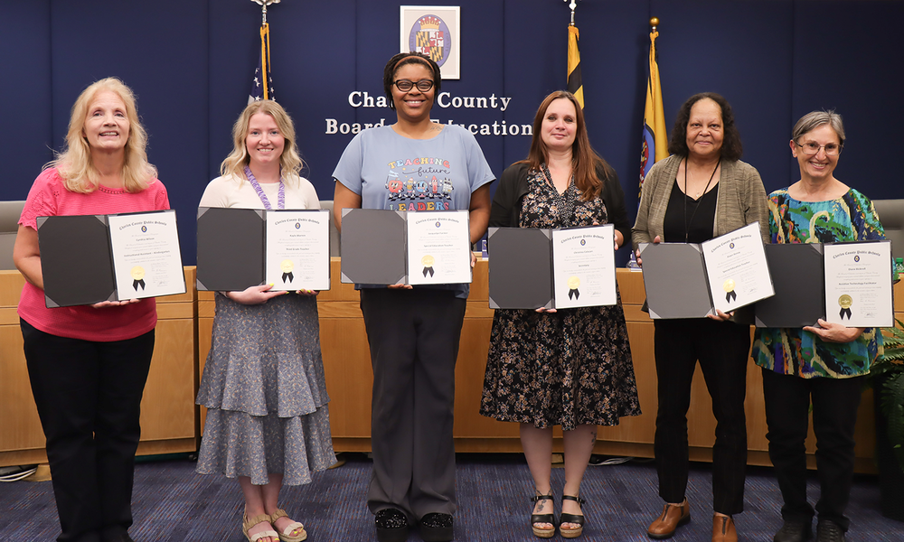 staff receiving board recognition in May