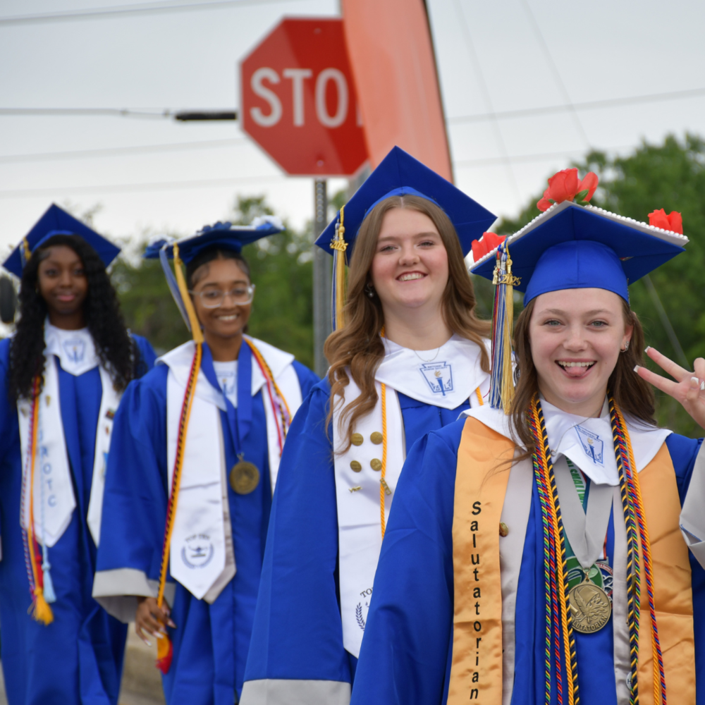 four students dressed for graduation