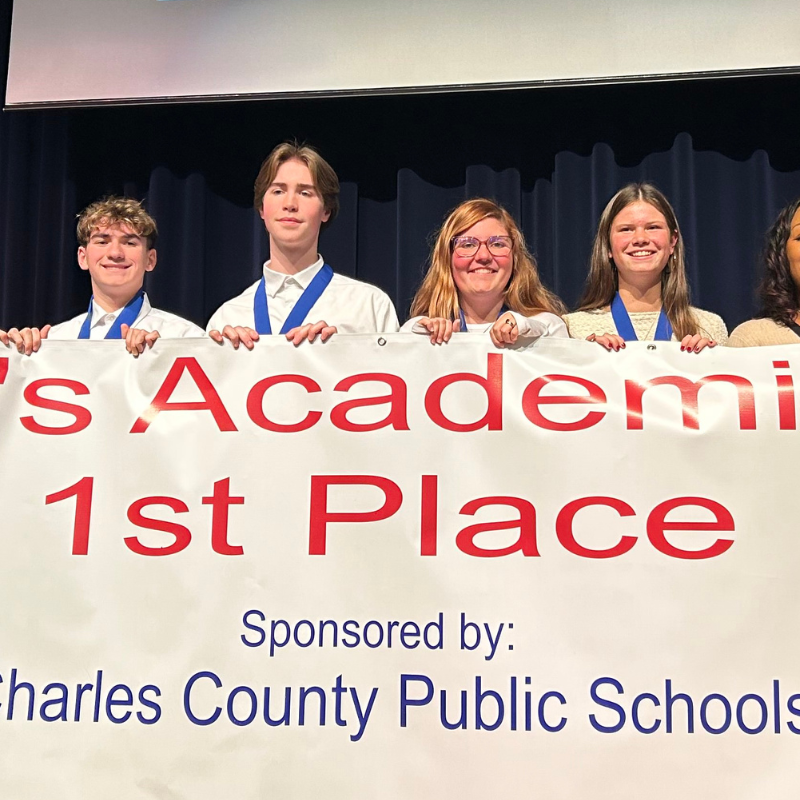 four students holding banner