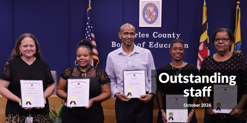row of five adults holding certificates