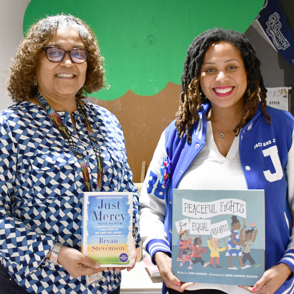 two women holding books