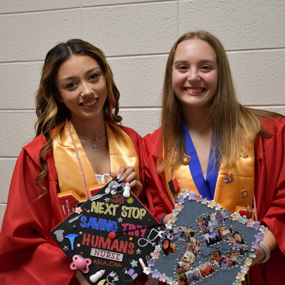 two students dressed for graduation