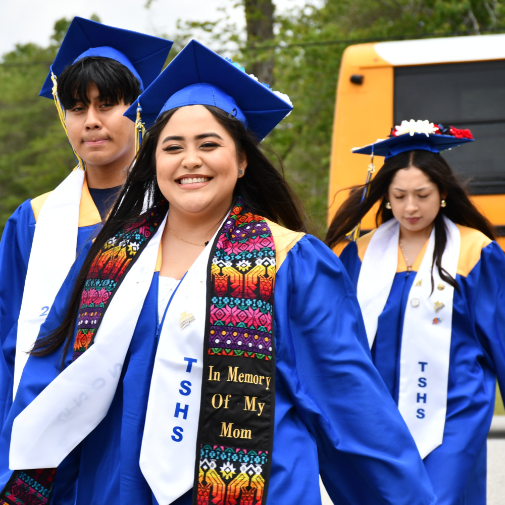 three students graduating