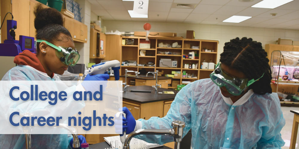 Two teen girls in robes and goggles conducting lab work