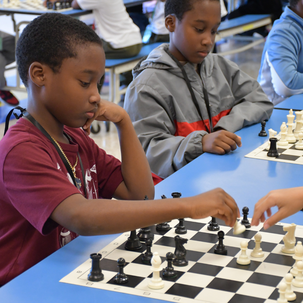 two students playing chess