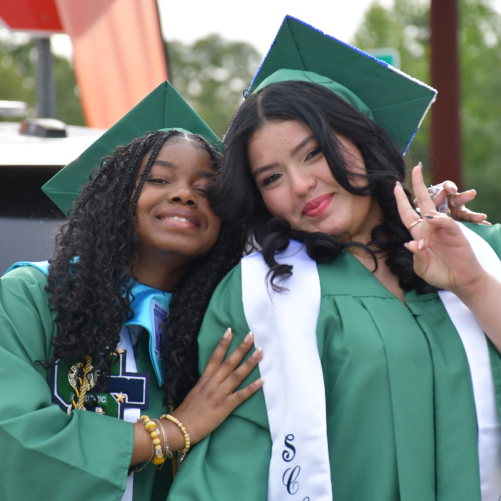 two students dressed for graduation