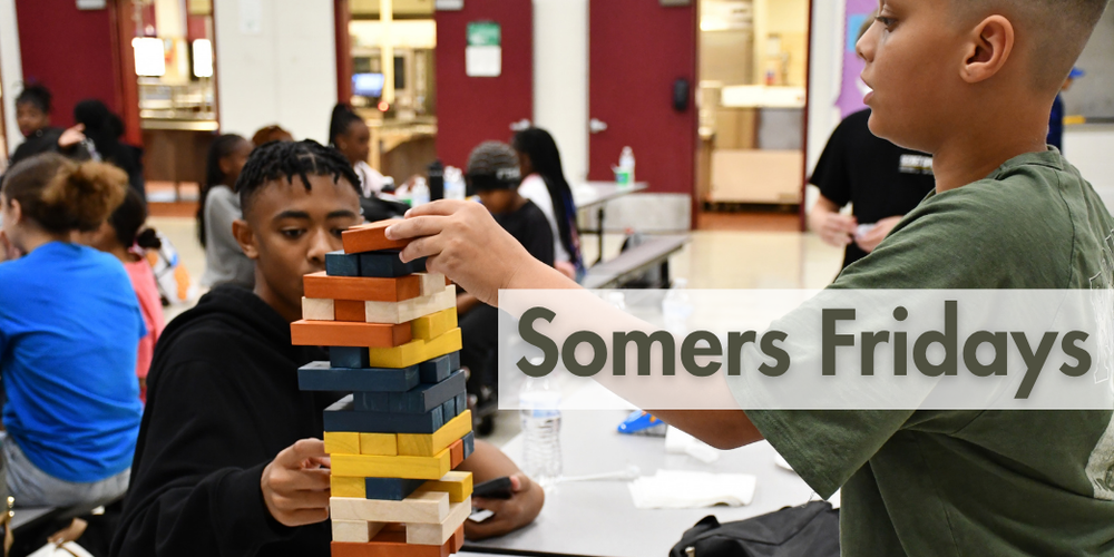 Two students play Jenga 