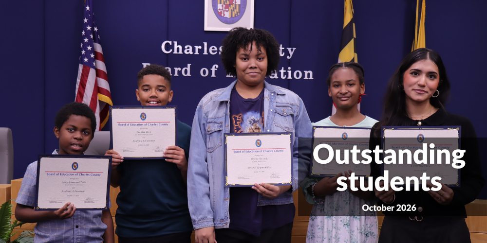 Five students in a row holding certificates