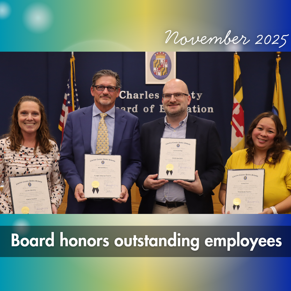 four staff members reciving awards