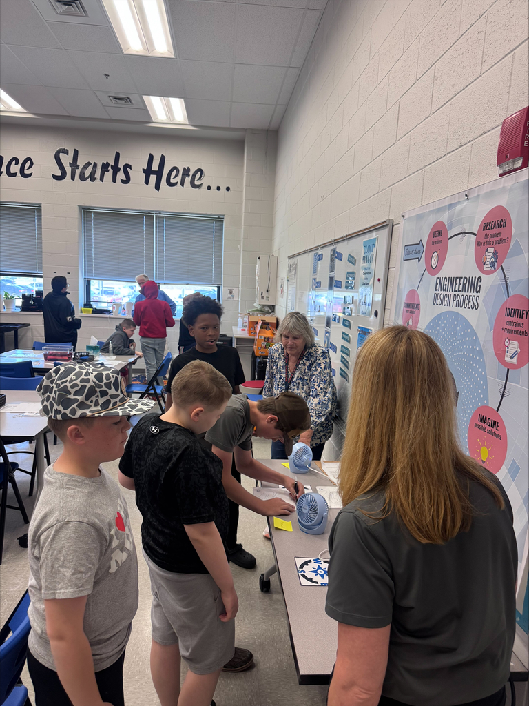 students standing and working in a science classroom