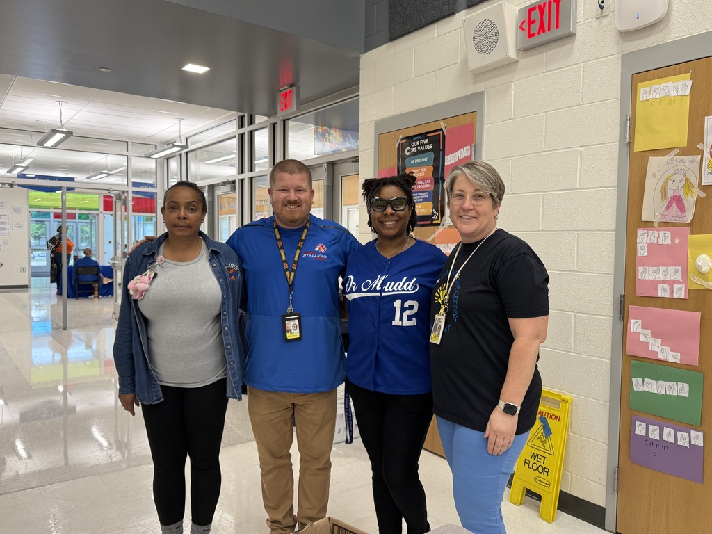    Dr. Mudd staff and middle school representatives pose together during the Middle School Sneak Peek family engagement event.