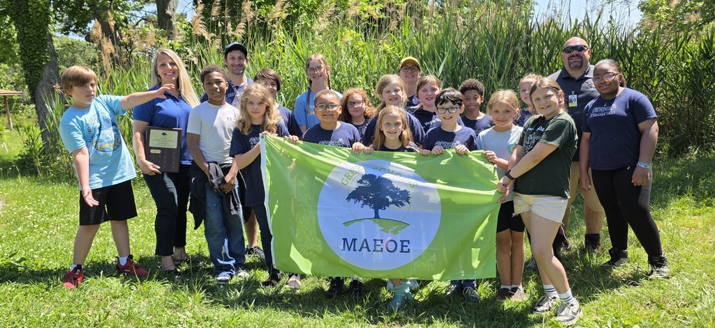 Mt. Hope staff and students hold a flag.