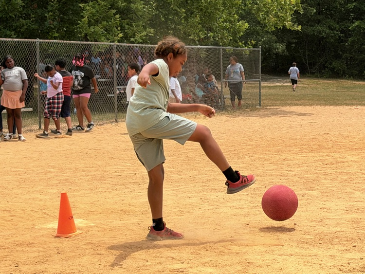child playing kickball