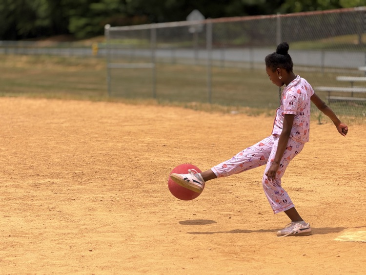 child playing kickball