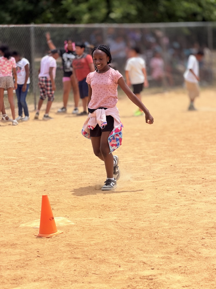 child playing kickball