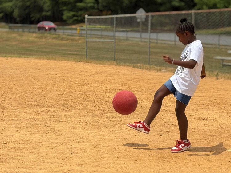 child playing kickball