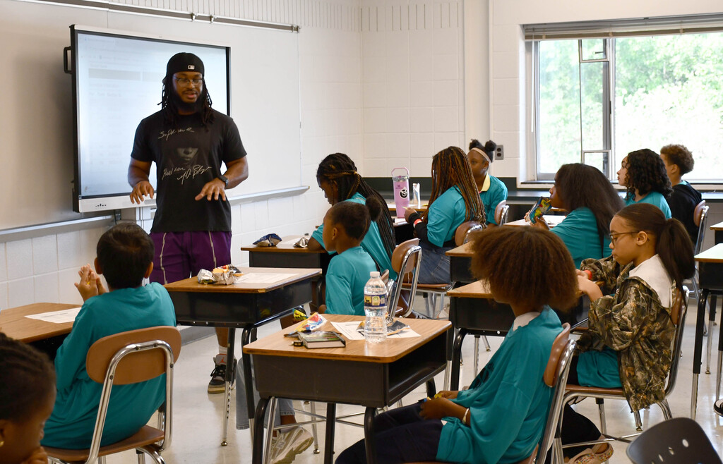 Teacher addressing a classroom of middle schoolers 