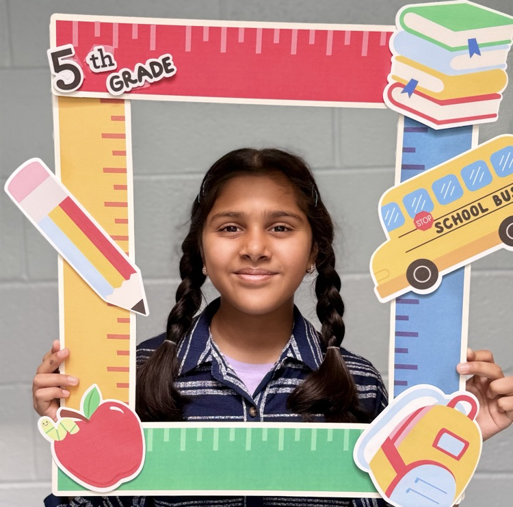student holding a 5th grade sign 