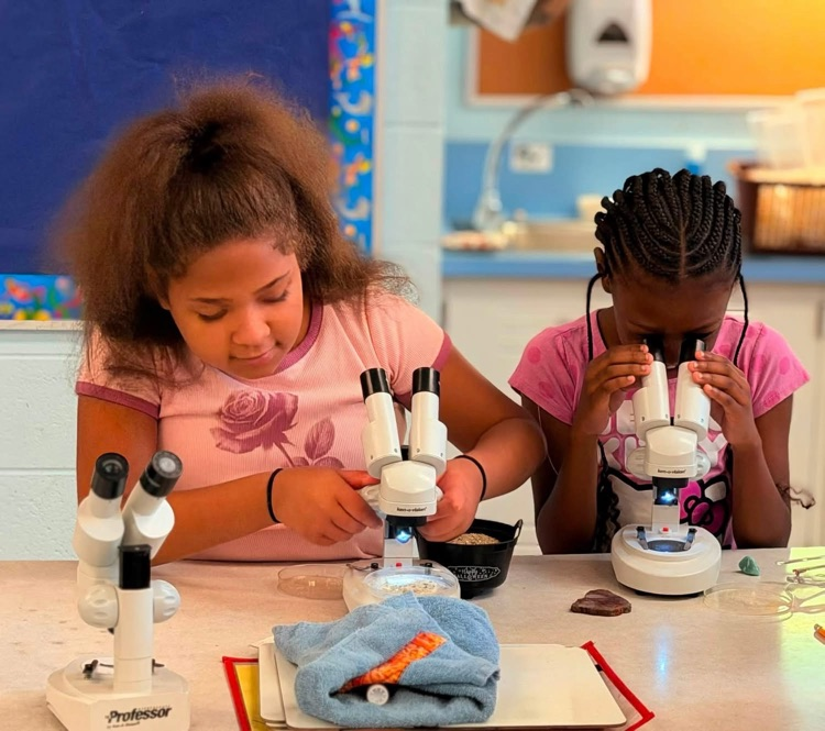 student looking in microscope