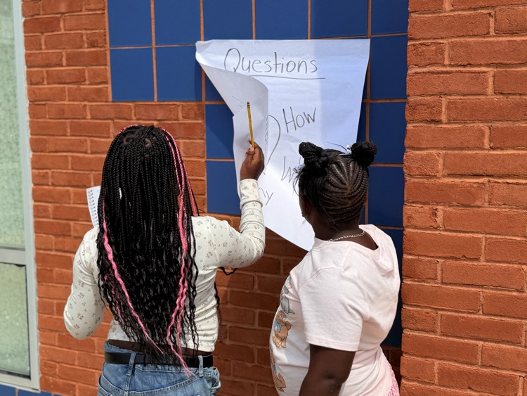 2 students looking at paper 