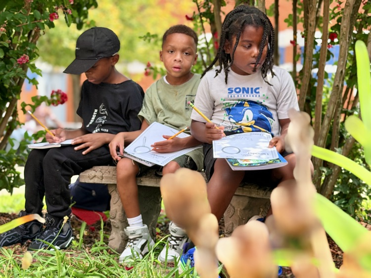 students sitting on bench 