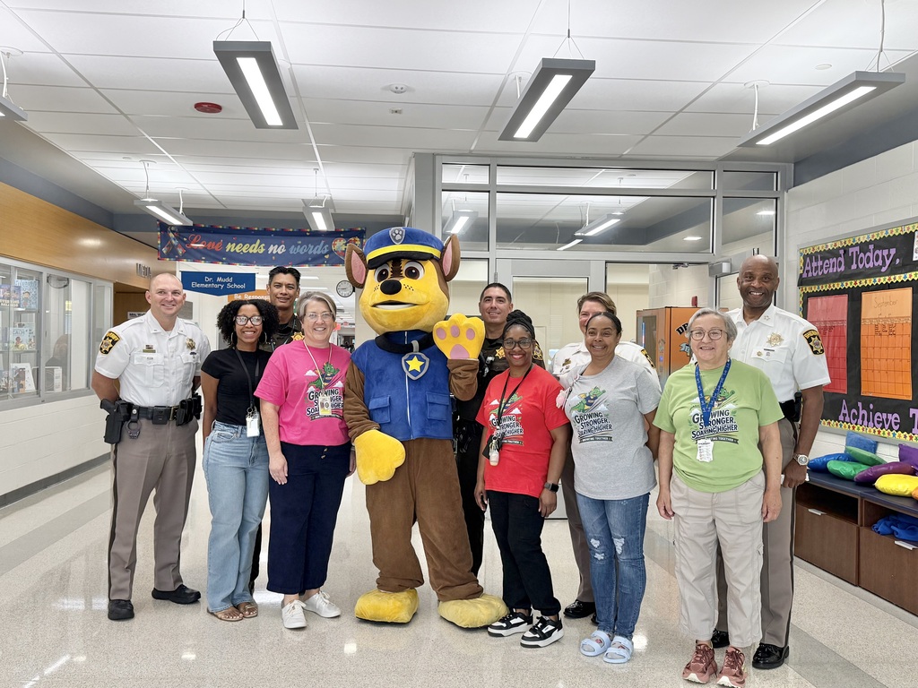Sheriff Troy D. Berry and another sheriff’s officer pose with Dr. Mudd students and a Paw Patrol character during the school visit.