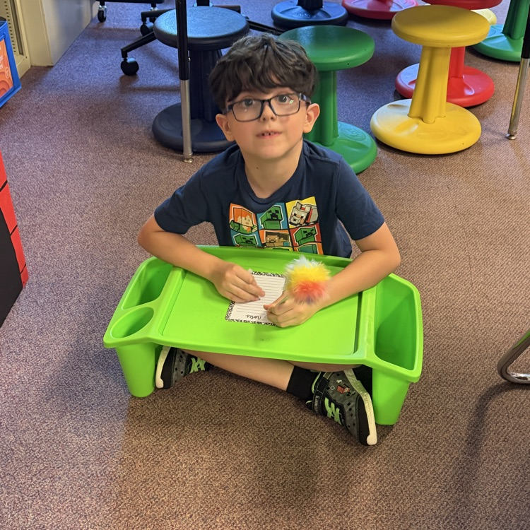 student sitting at lap desk