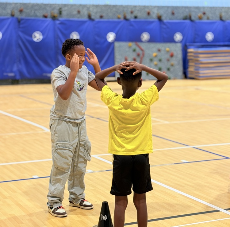 students with hands on their heads 