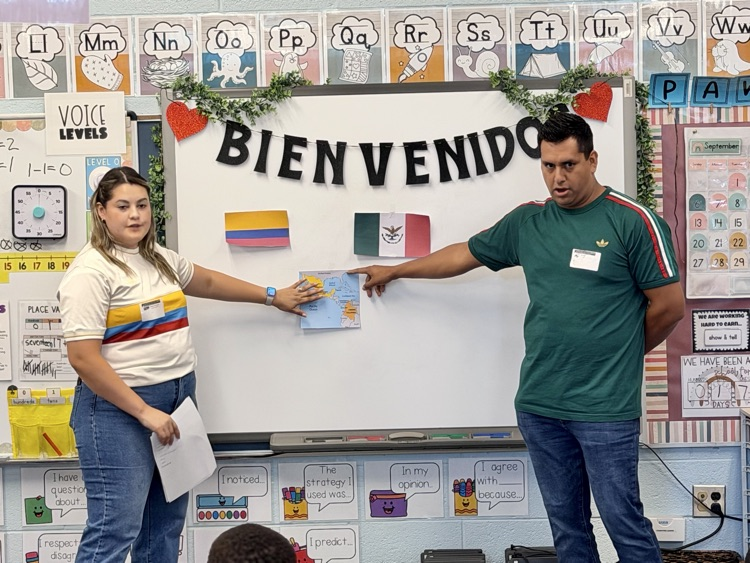 2 people pointing to a map