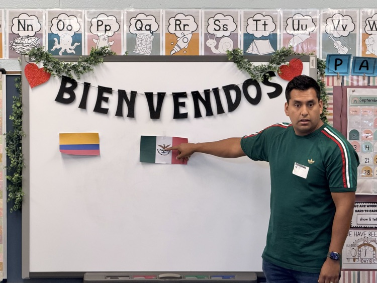 man pointing to Mexican flag