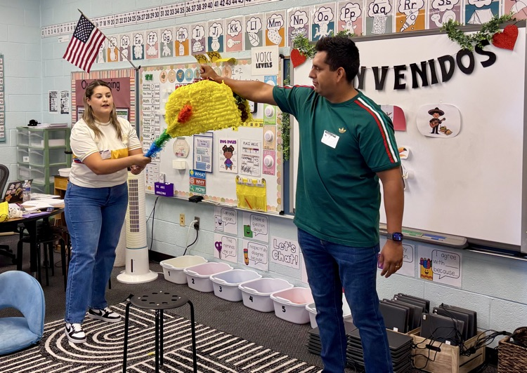2 people playing piñata 