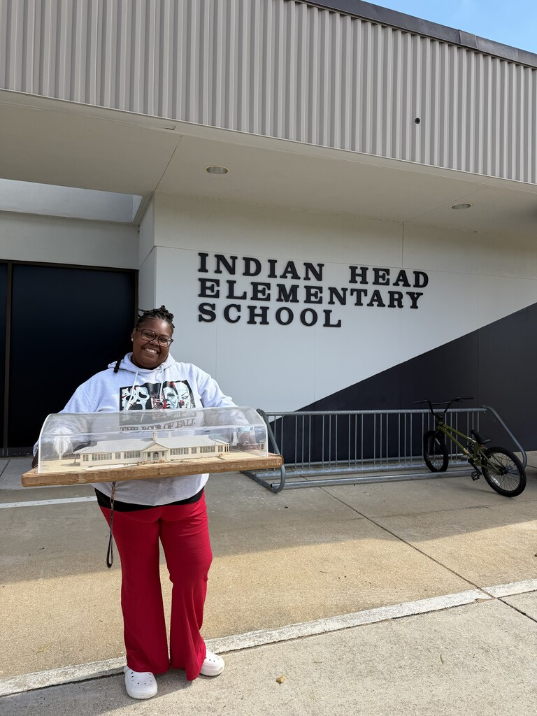 the original mock up of IHES being held by our Family Liaison Mrs. Tyneka Dorsey