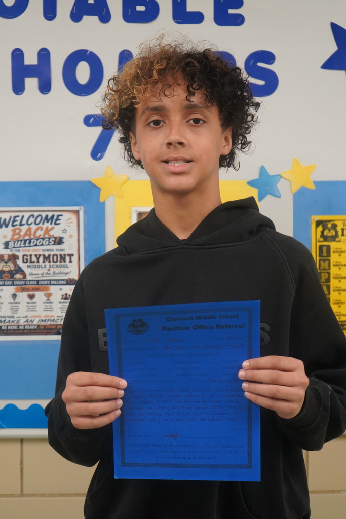 Student holding Positive Office Referral