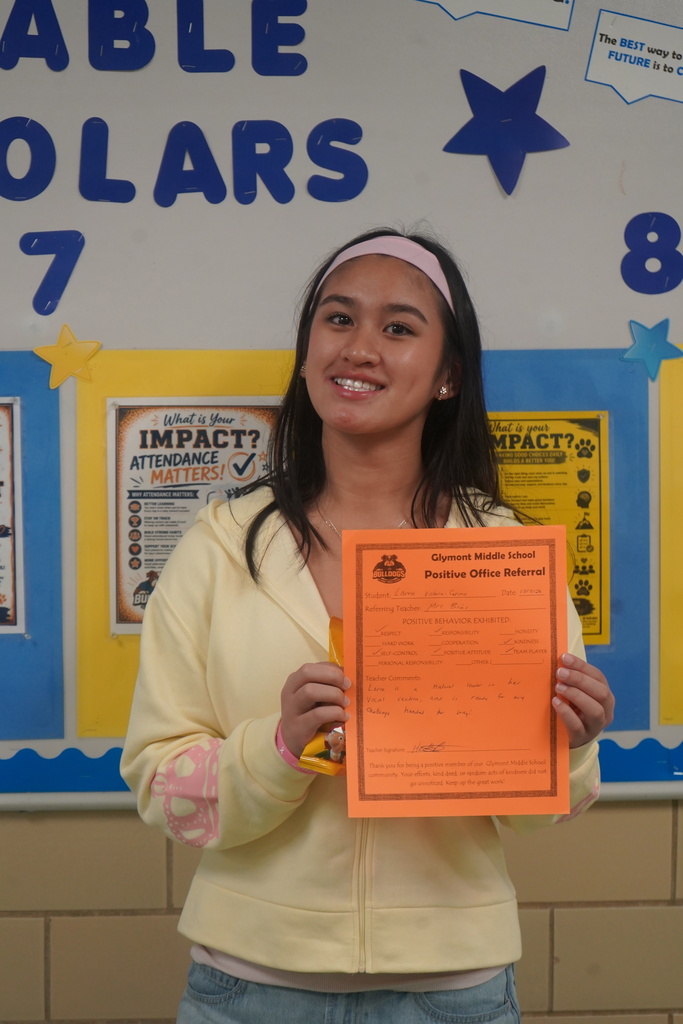 Student holding Positive Office Referral