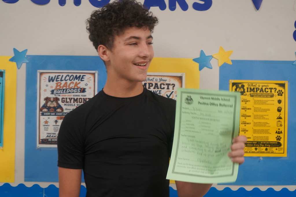 Student holding Positive Office Referral