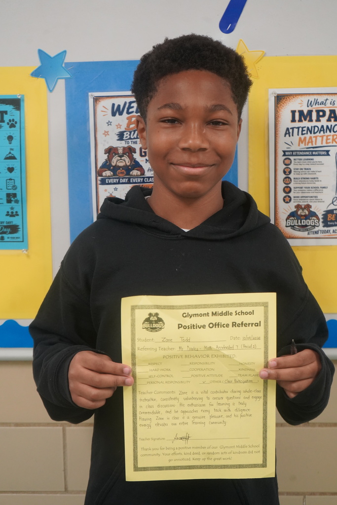 Student holding Positive Office Referral