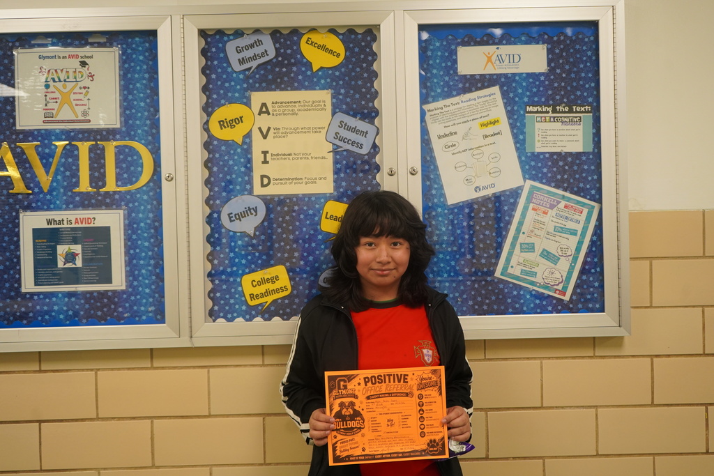 Student holding Positive Office Referral
