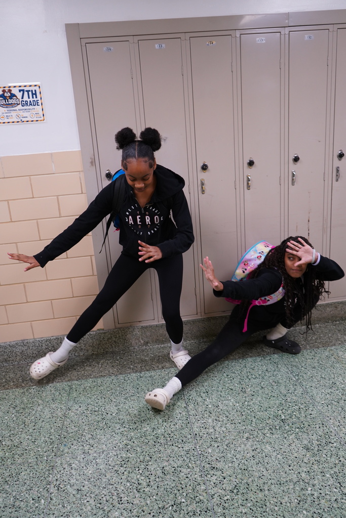 Two students wearing matching hoodies, leggings, and crocs for Twin Day.