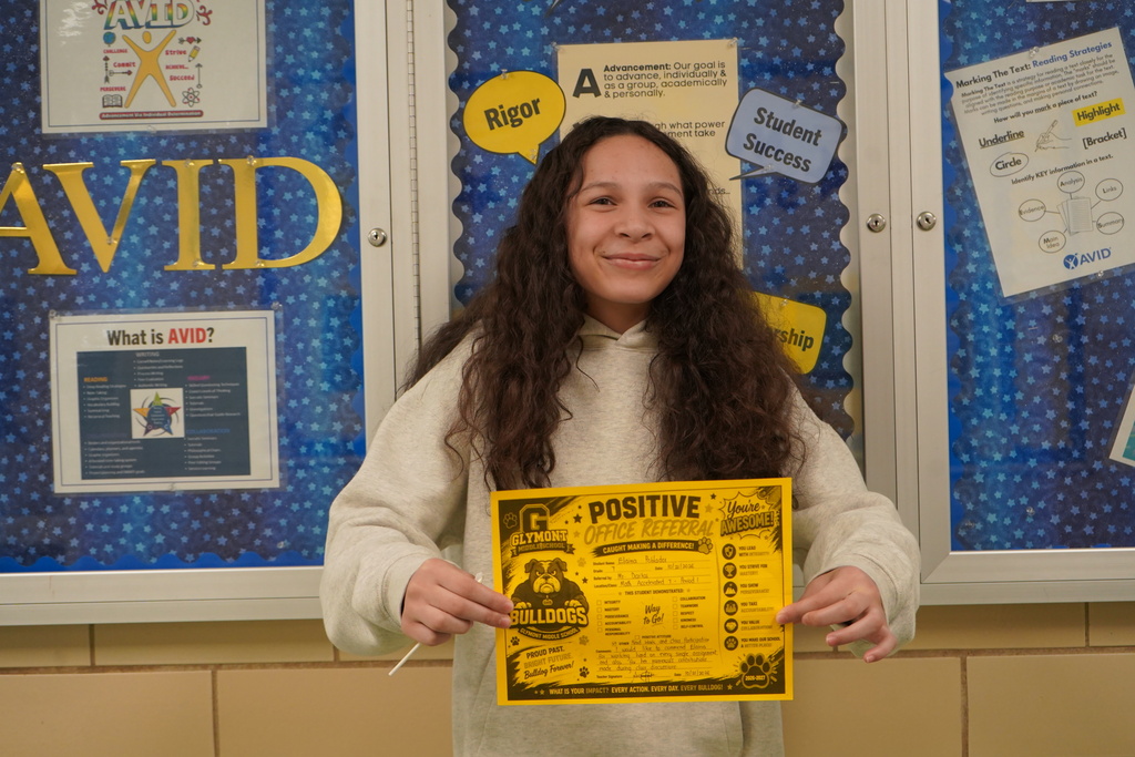 Student holding Positive Office Referral