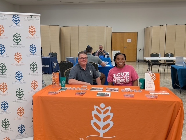 Man and woman behind a table