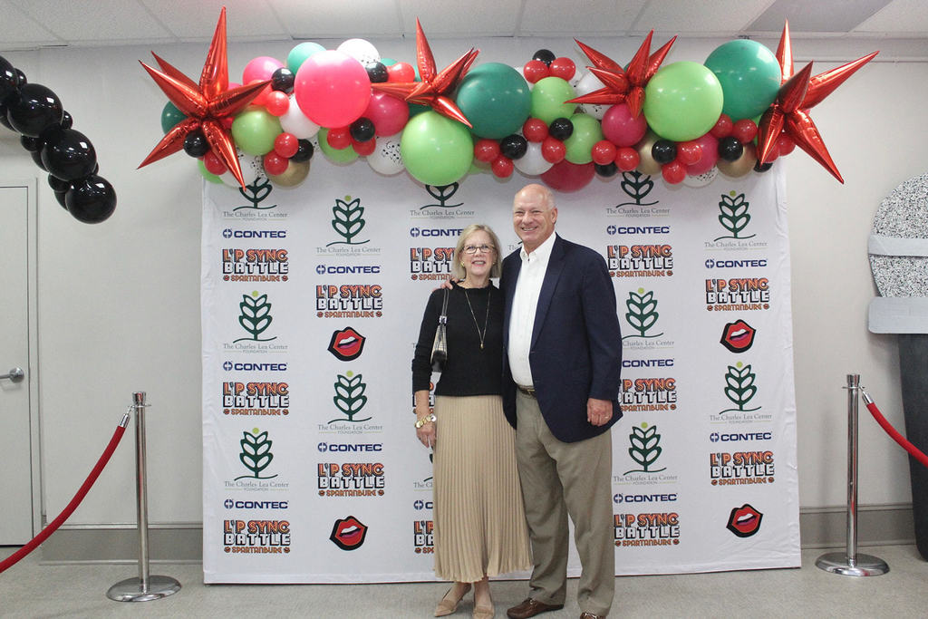 Attendees smiling at the camera