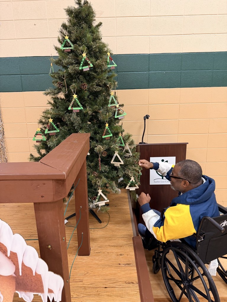 man in wheelchair decorating treee