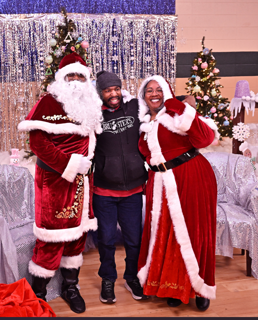 santa and mrs claus with a visitor