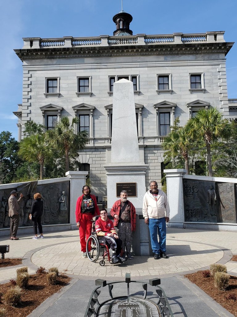 4 men at statehouse monument
