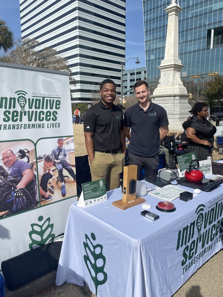 2 men at enabling tech table at statehouse