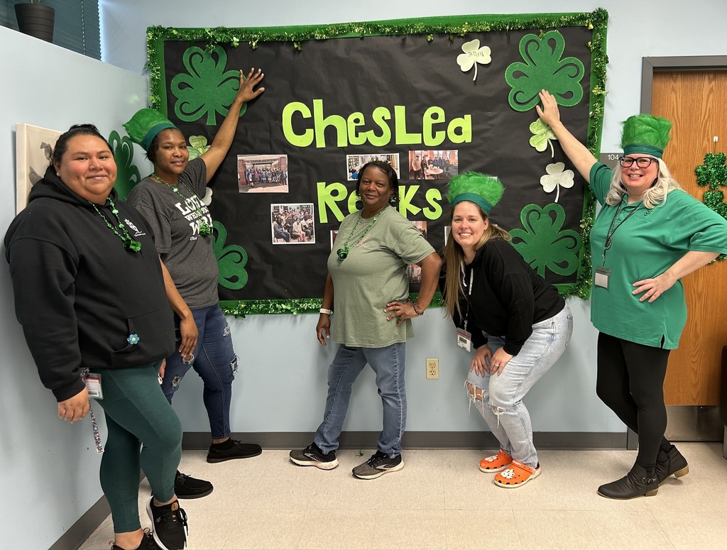 5 women in front of a bulletin board