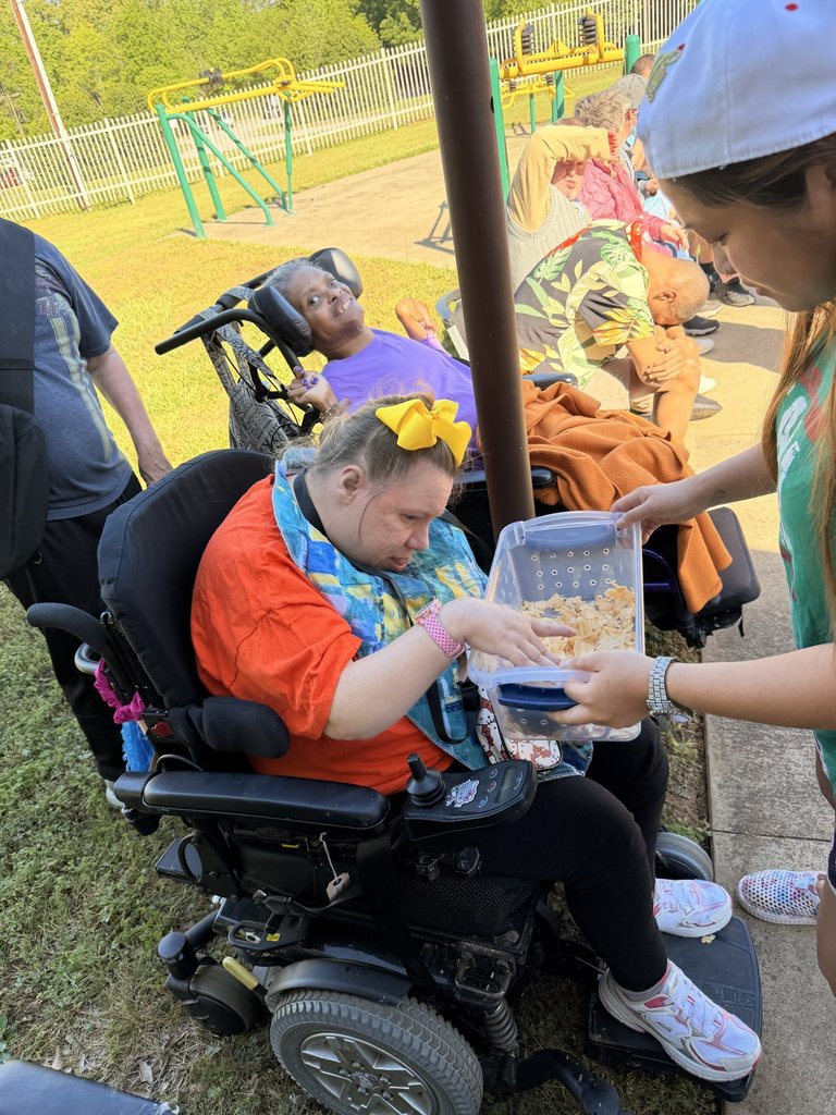 Woman in a wheelchair petting snails