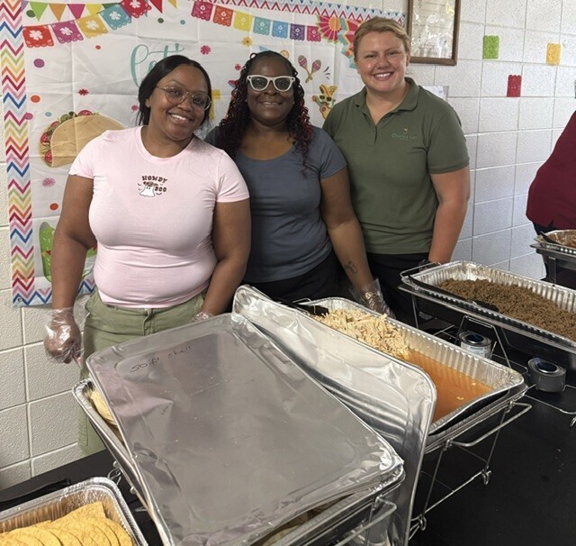3 women serving tacos